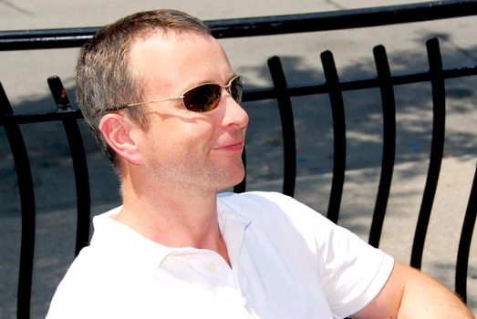 Portrait of a smiling man wearing sunglasses in outdoor cafe