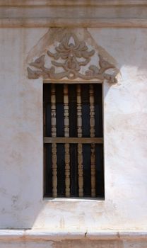 Rustic window with a diagonal shadow on a 16th century Catholic Mission.