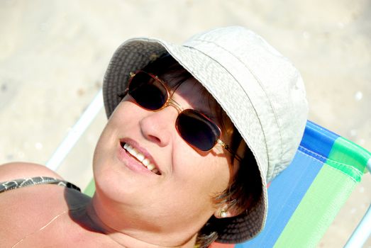 Mature woman relaxing in a beach chair