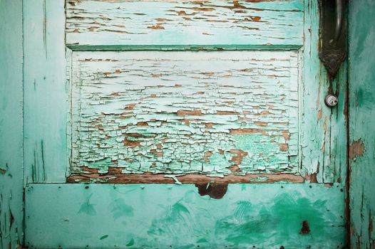 Detail of Blue Green Door with Peeling Paint.