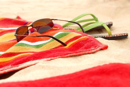 Bright colorful towels and other beach items on a beach