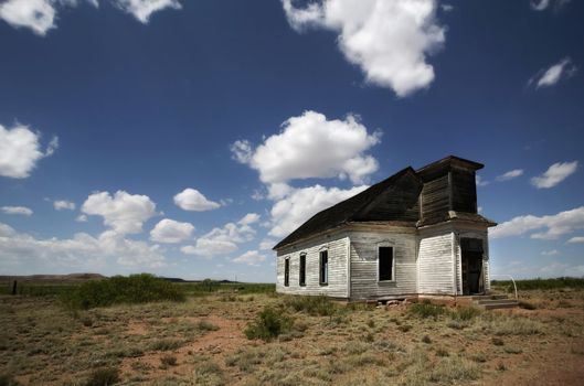 Abandoned and forgotten rural church against a deep blu sky. 