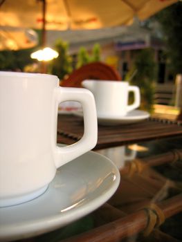 two white ceramic cups of coffee on table