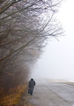 woman walking in foggy day in the ukranian countryside