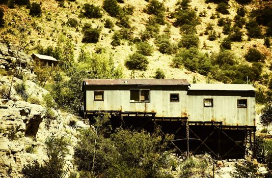 Corrugated metal miner's shack perched on an Arizona hillside.