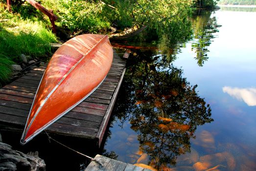 Canoe on wooden dock on a lake