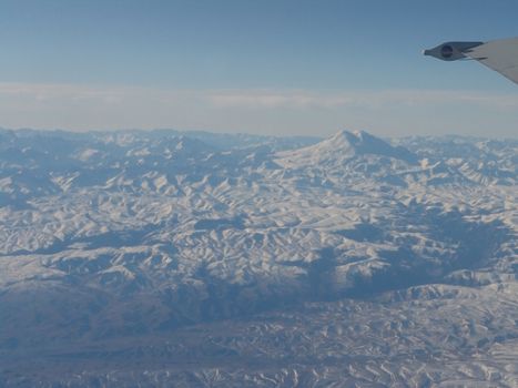 Snow-bound mountains from bird flight                            