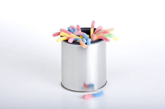 Shiny can of candy worms isolated against a white background