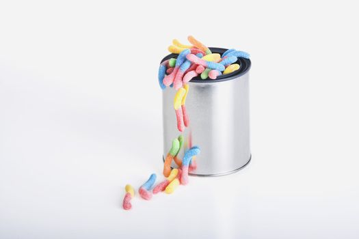 Shiny can of candy worms isolated against a white background