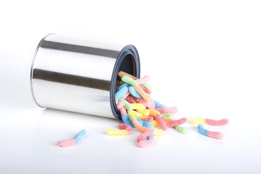 Shiny can of candy worms isolated against a white background