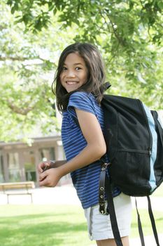 Eight year old girl excited about first day of school.;