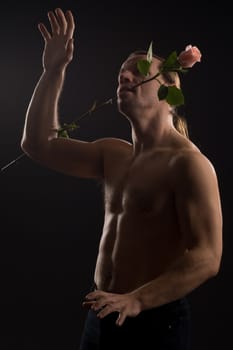 clambering romantic man with pink rose
