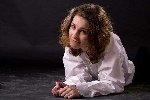 smiling lying woman on black background
