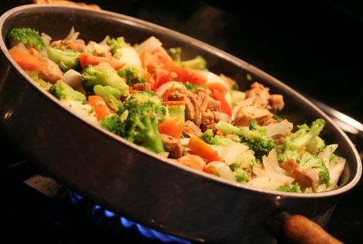 Chicken and vegetable stirfry in a wok;