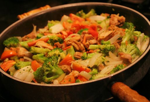 Chicken and vegetable stirfry in a wok;