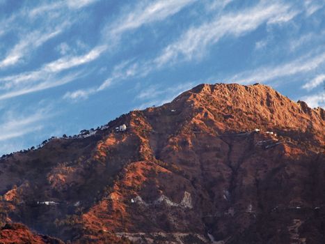 Landscape of dawn shadows and sunrays on Vaishnoo Devi at the foothills of Himalayas from Katra, crop space and empty areas