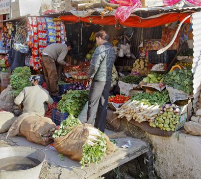 Katra Jammu Kashmir India - December 14, 2011: Shoppers trading at fresh vegetable stall on Katra Road in Jammu Kashmir India