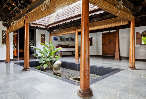 Kerala architecture of inner courtyard giving daylight to inner quarters living area in an bungalow