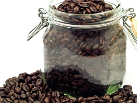 Coffee Beans and a Clear Glass Container with more Coffee
