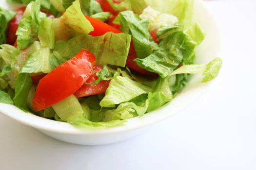 Healthy vegetarian Salad on the white plate over white 