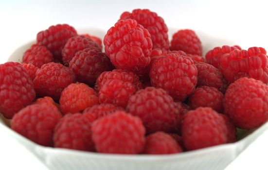 Raspberries Close Up in a Bowl on White