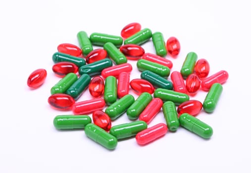 Colorful red and green pills on white background 