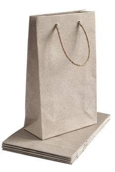 Recycled paper bags with hemp rope handles isolated on white background