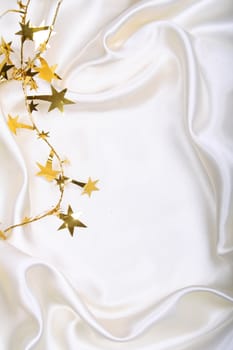Golden stars and spangles on white silk