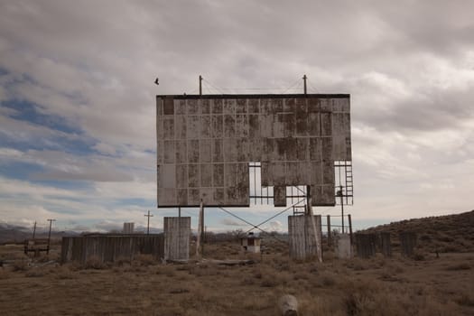 abandoned movie theater int he desert with clouds