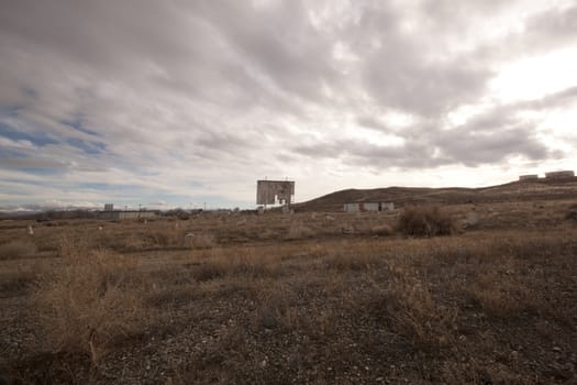 abandoned movie theater int he desert with clouds