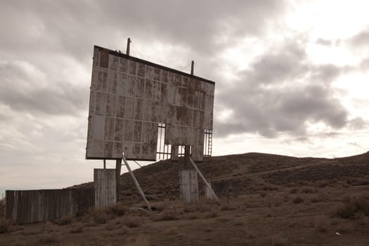 abandoned movie theater int he desert with clouds