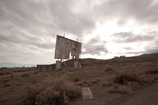abandoned movie theater int he desert with clouds