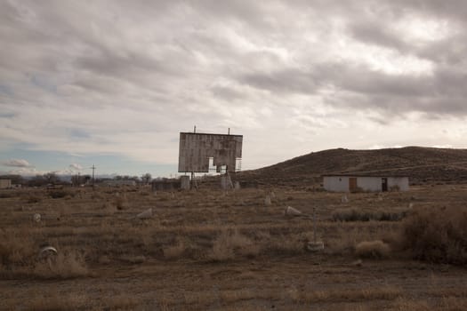 abandoned movie theater int he desert with clouds