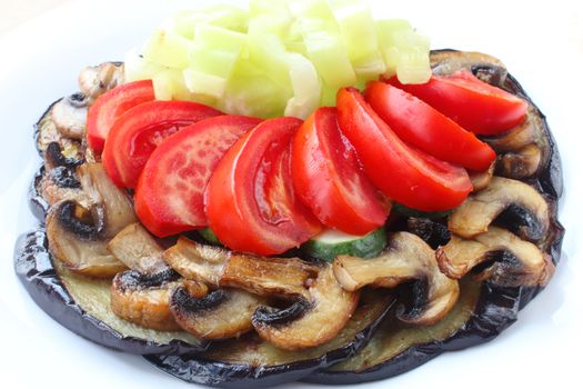 Fried eggplants and mushrooms with fresh tomatoes, cucumbers and pepper on white plate
