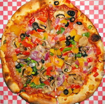 A Fresh and Healthy Vegetable Pizza on Red Checked Paper