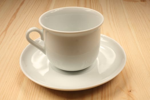 White cup on wood table