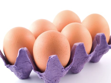 Six Brown Eggs in an Egg Carton Isolated on White