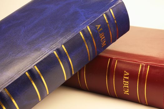 Red and blue photo albums on white background.