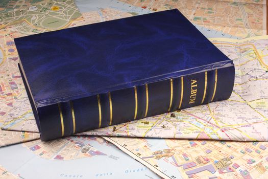 Blue photoalbum on map background.