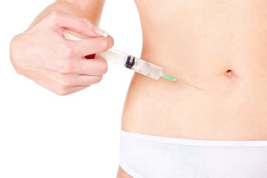 Syringe on woman's stomach, isolate on white. Health concept