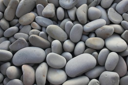 Pebble background, gray pebbles on sea coast