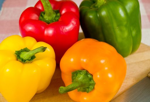 Bell Peppers on a Wooden Cutting Board with Knife