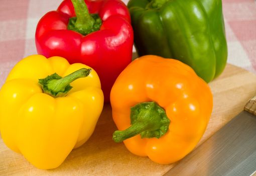 Bell Peppers on a Wooden Cutting Board with Knife