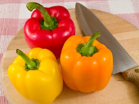 Bell Peppers on a Wooden Cutting Board with Knife