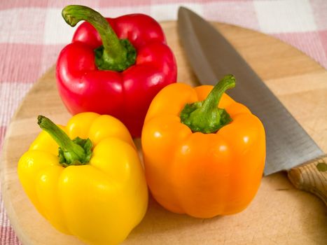 Bell Peppers on a Wooden Cutting Board with Knife