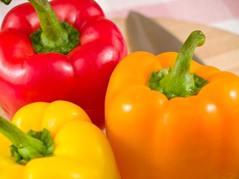 Bell Peppers on a Wooden Cutting Board with Knife