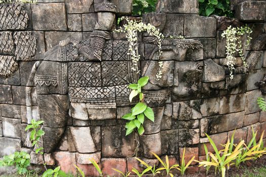 old scultpure of elephant in wall in thailand