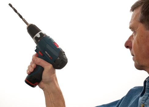 Senior male holding a power drill isolated against white