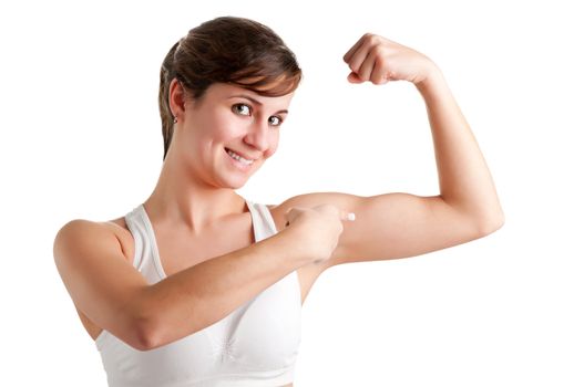 Woman smilling and pointing at her bicep after an workout, isolated in a white background