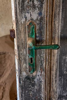 a door in kolmanskop's ghost town near luderitz namibia